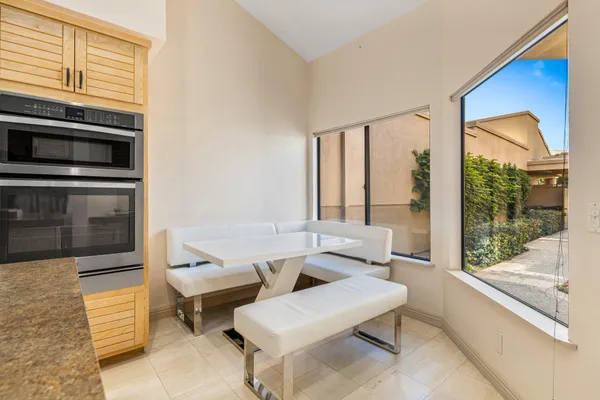 a living room with furniture and a floor to ceiling window