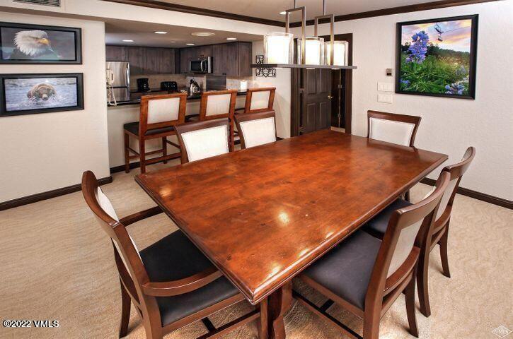 210 Offerson Road, Unit 2124 Beaver Creek, CO 81620 - Photo 6 of 16 a view of a dining room with furniture and a chandelier