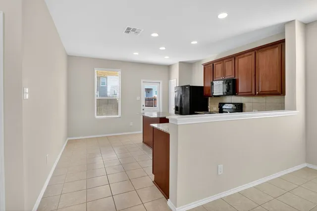 a kitchen with stainless steel appliances a refrigerator sink and microwave