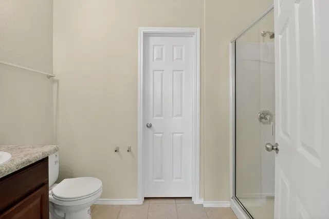 a bathroom with a glass shower door