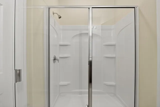 a bathroom with a granite countertop sink toilet a shower and a mirror