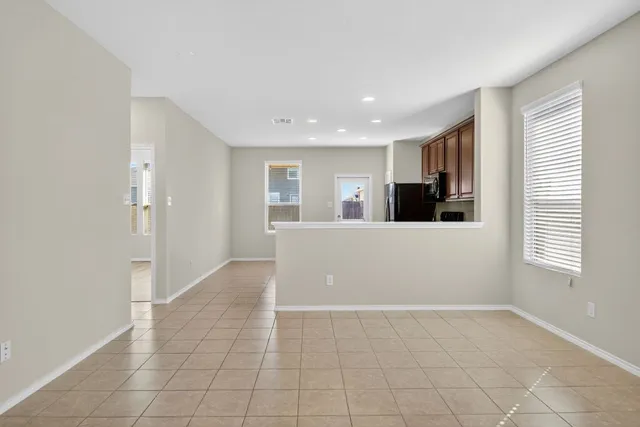 a view of a kitchen with an empty space and a window