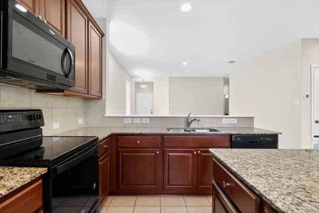 a kitchen with stainless steel appliances granite countertop a sink and stove