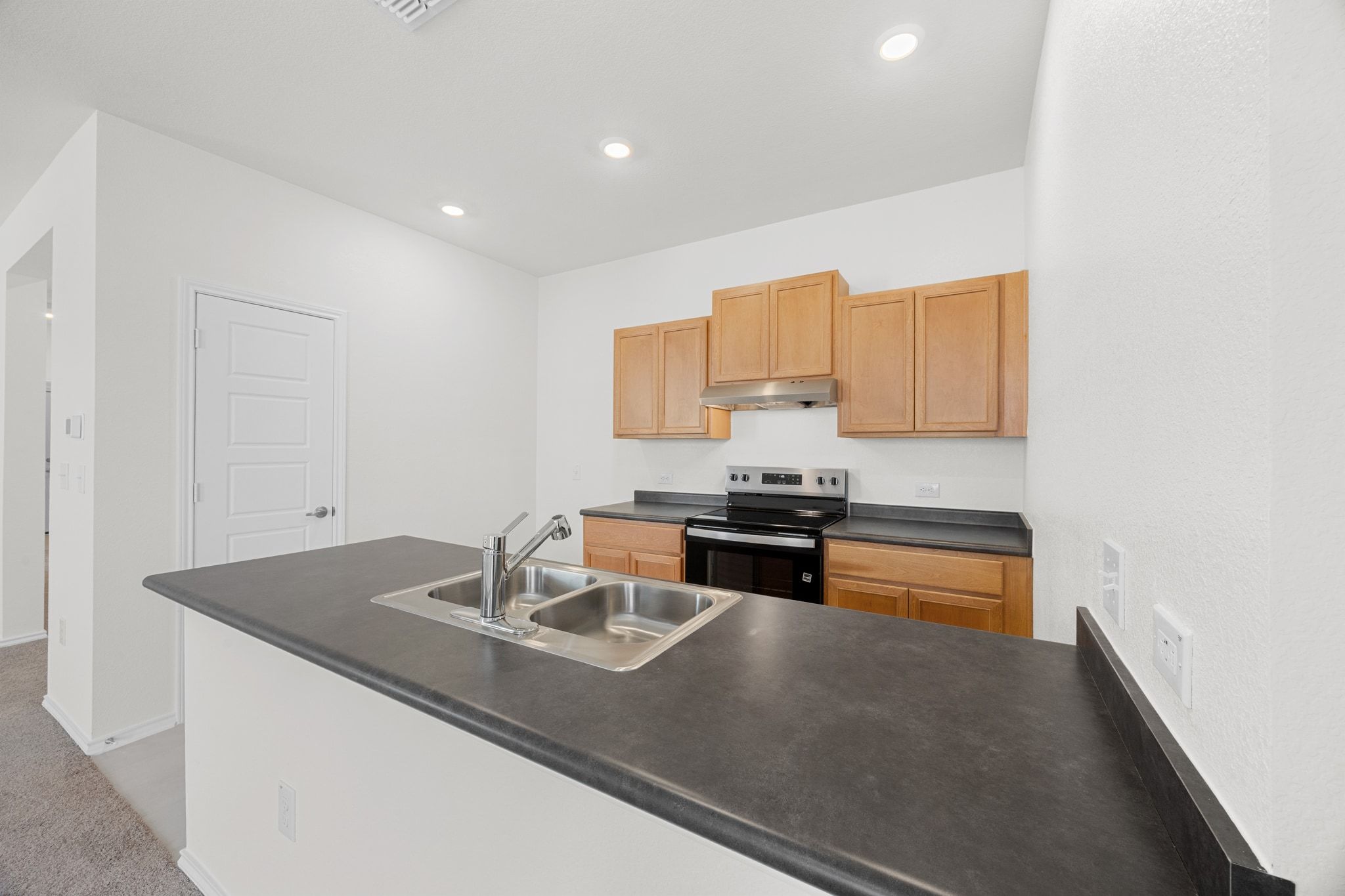 12102 Cantabria Road Austin, TX 78748 - Photo 10 of 29 a kitchen with stainless steel appliances a sink a stove and a refrigerator