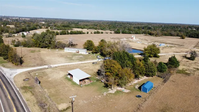 an aerial view of a house with a yard