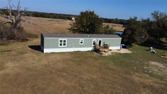 a swimming pool with outdoor seating and trees