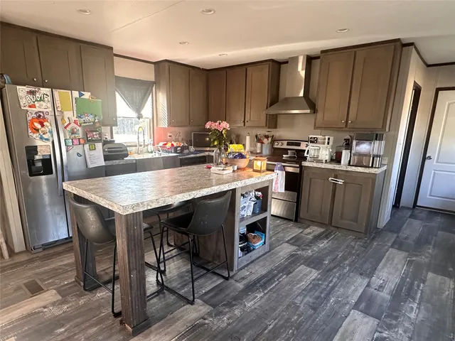 a kitchen with granite countertop a sink appliances a counter space and cabinets