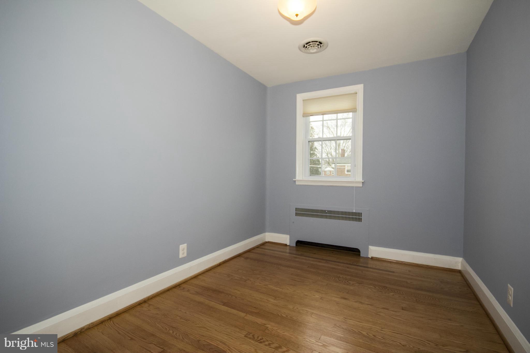 226 Murdock Road Baltimore, MD 21212 - Photo 11 of 19 an empty room with wooden floor and windows