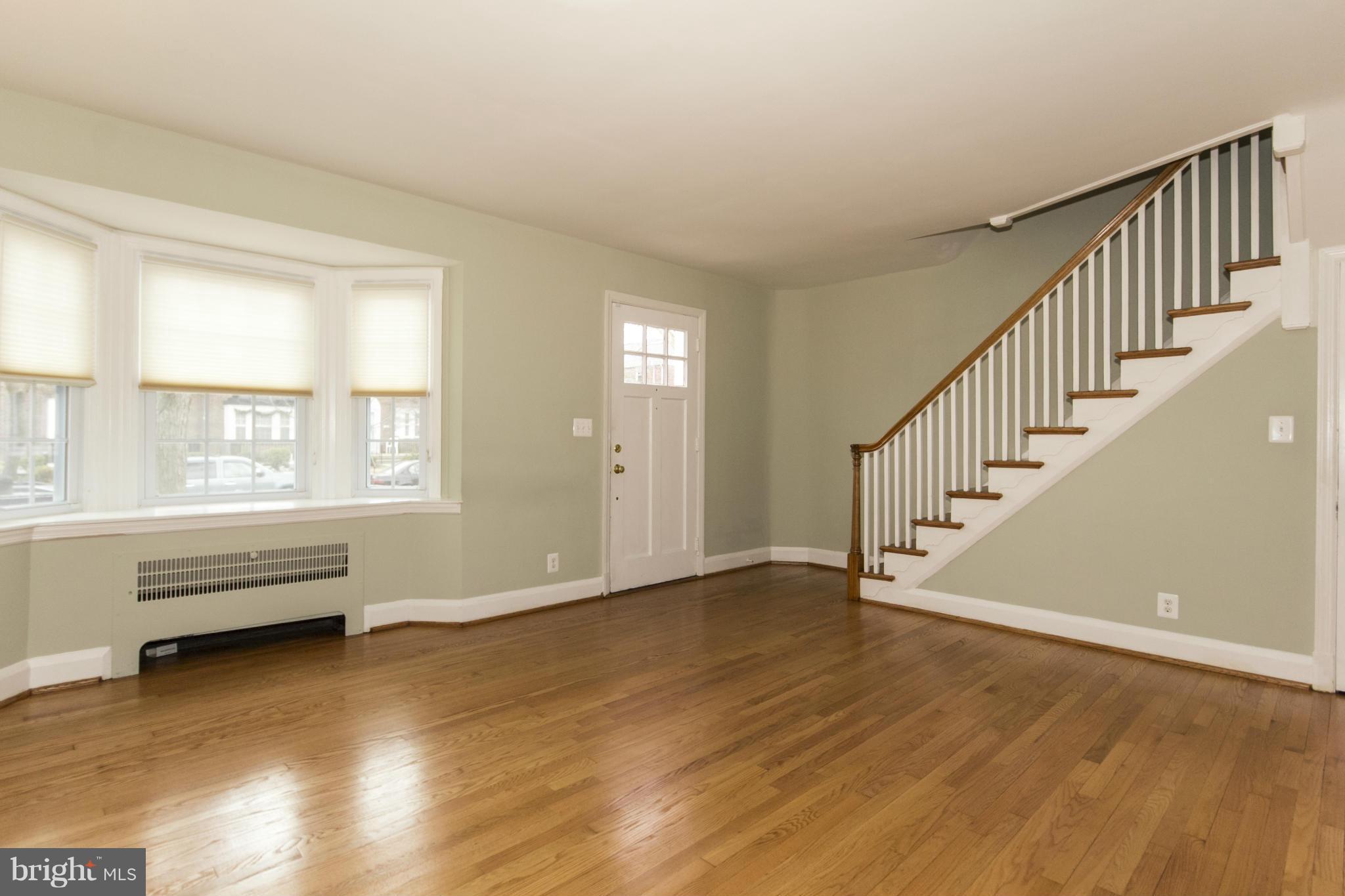 226 Murdock Road Baltimore, MD 21212 - Photo 4 of 19 a view of an empty room with wooden floor and a window