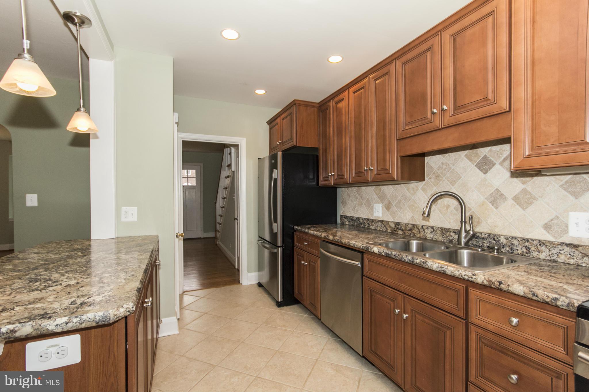 226 Murdock Road Baltimore, MD 21212 - Photo 7 of 19 a kitchen with stainless steel appliances granite countertop a sink and cabinets