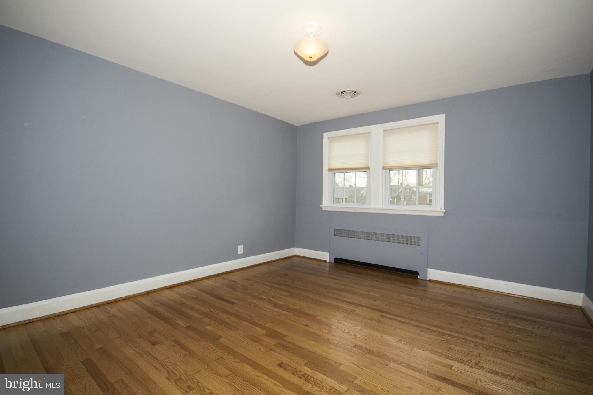 226 Murdock Road Baltimore, MD 21212 - Photo 8 of 19 an empty room with wooden floor and windows