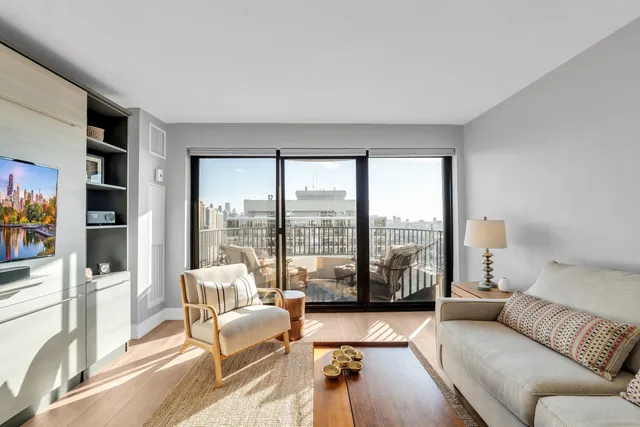 a living room with furniture and floor to ceiling windows