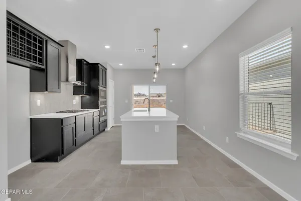 a kitchen with kitchen island a sink stainless steel appliances and window