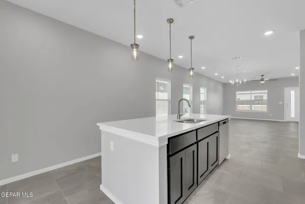 a bathroom with a sink a large mirror and vanity