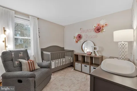 a bedroom with a bed and a refrigerator