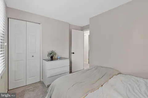 a bedroom with a bed potted plant with the window
