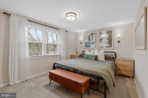 a bedroom with a bed and a table