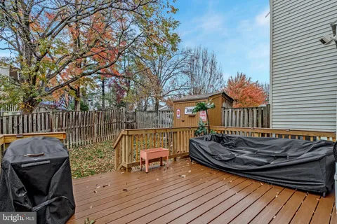 a view of a house with a small yard and wooden fence