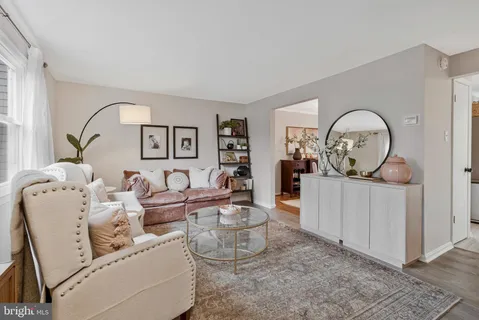 a living room with furniture a mirror and a window