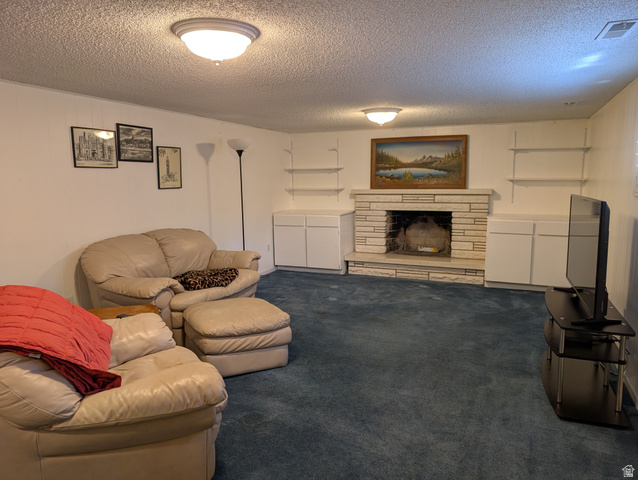 1411 Millbrook Way Bountiful, UT 84010 - Photo 26 of 36 Basement living room with stone-clad fireplace, flanked by built-in lower cabinetry and open shelving
