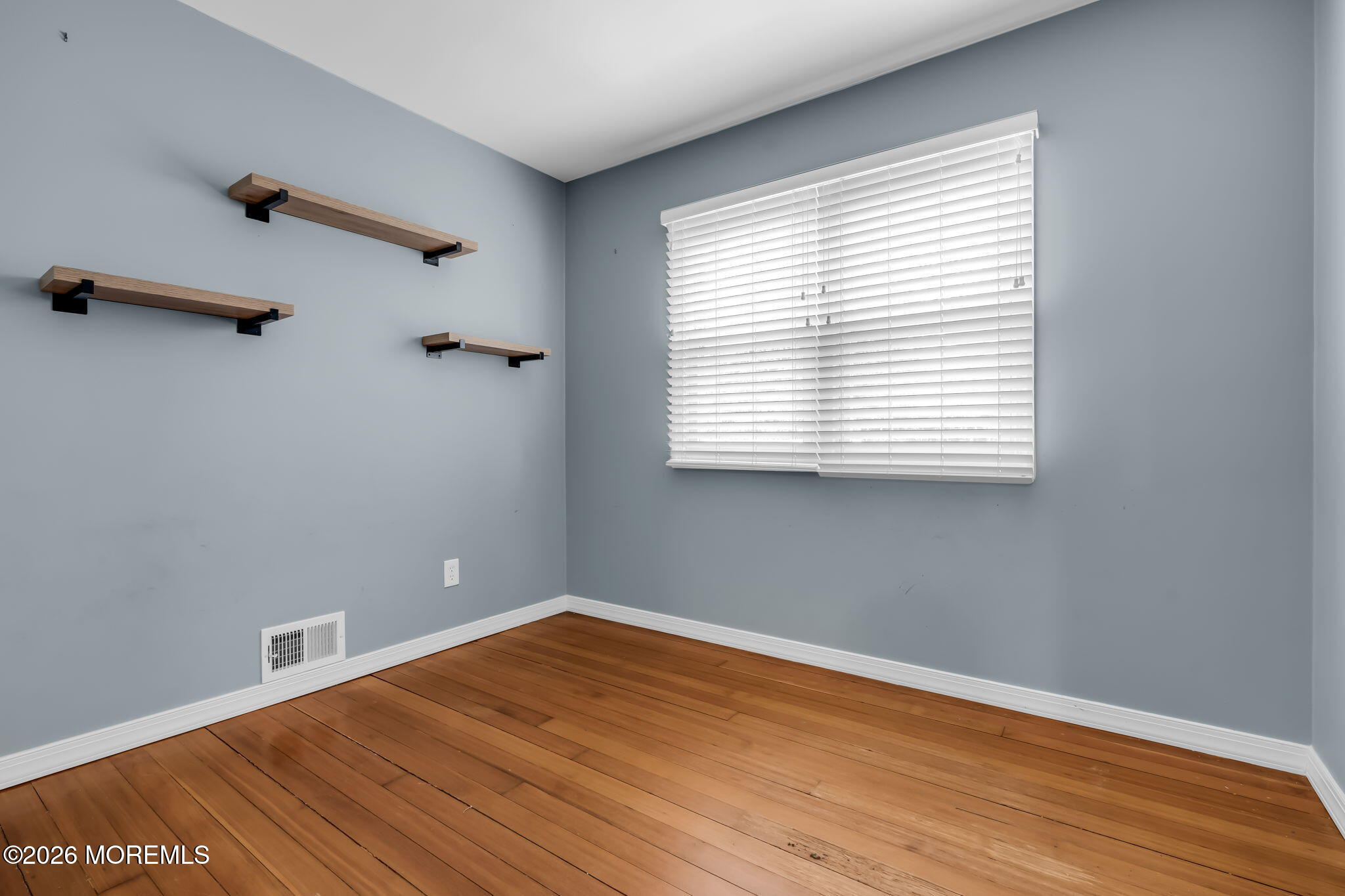593 Beach Plum Road Brick, NJ 08723 - Photo 22 of 38 an empty room with wooden floor and windows