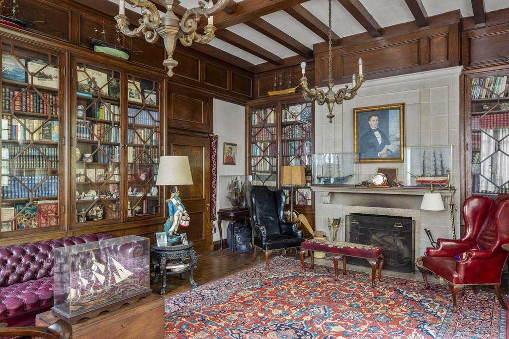 39 Clyde Street Brookline, MA 02467 - Photo 16 of 31 a living room with furniture a fireplace and lots of windows