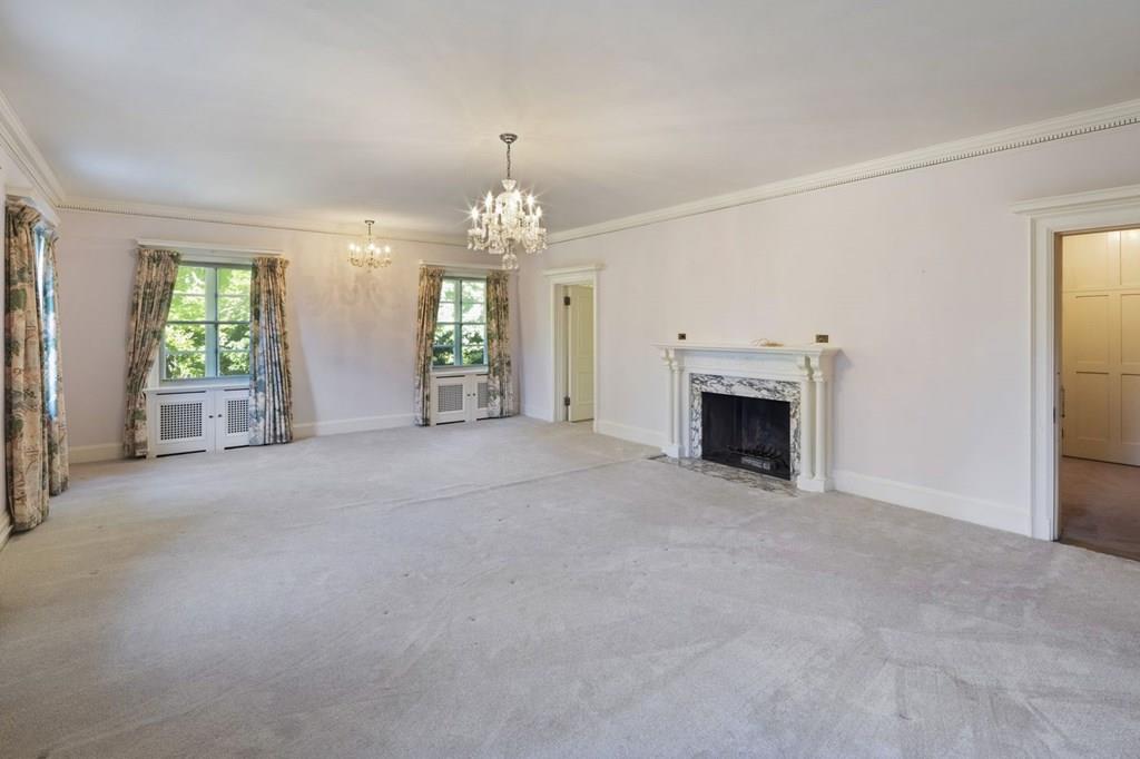 39 Clyde Street Brookline, MA 02467 - Photo 27 of 31 an empty room with fireplace and chandelier