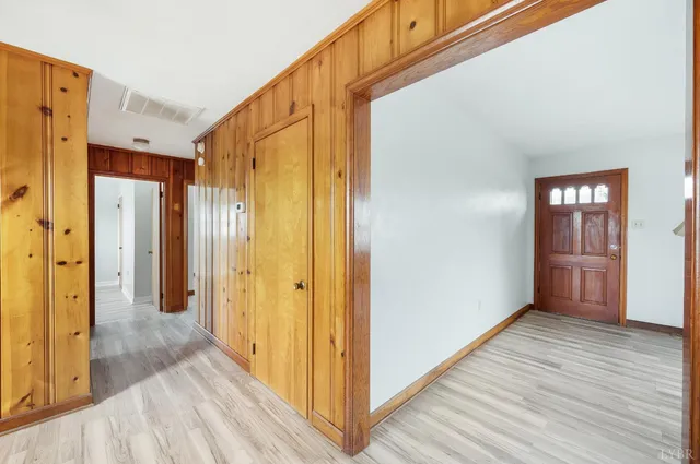 a view of a room with wooden floor and window
