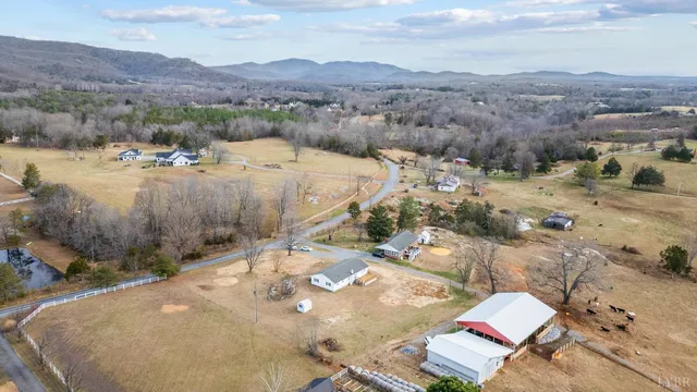 a view of side of a house with snow on the road