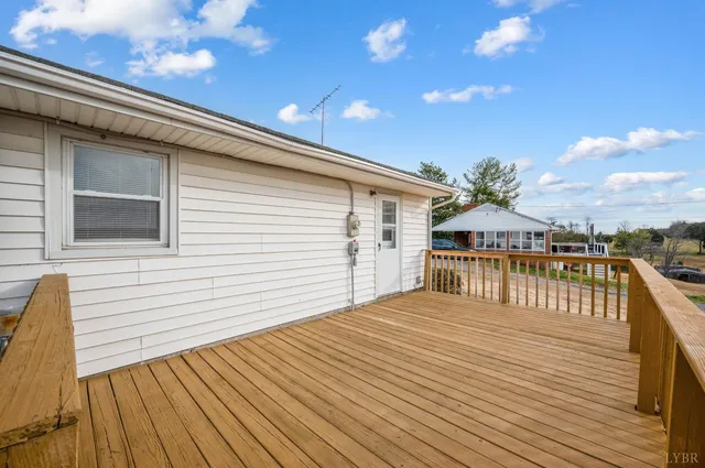 a front view of a house with large trees