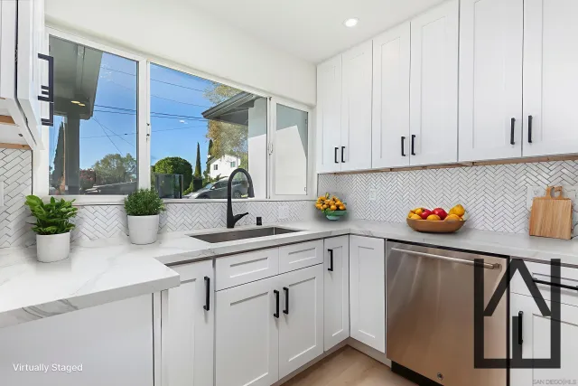 a kitchen with stainless steel appliances granite countertop a sink a counter space and cabinets