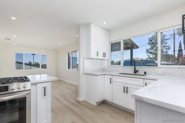 a kitchen with a sink stove and cabinets
