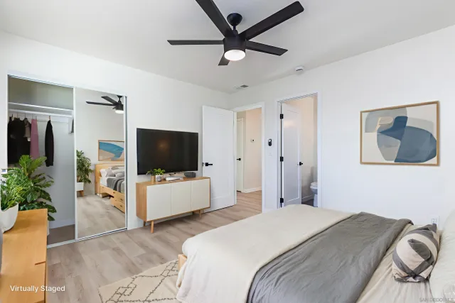 a bedroom with a bed and a flat screen tv