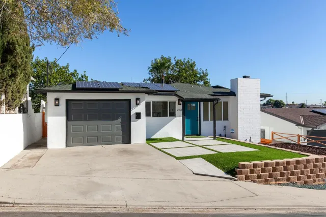 a front view of a house with a garden and yard
