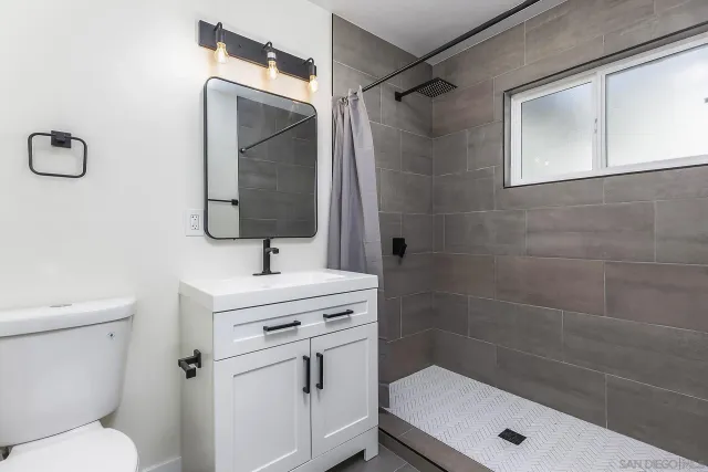 a view of a big room with wooden floor and windows