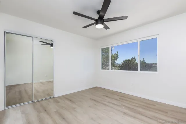 a bedroom with a balcony a bed and a flat screen tv