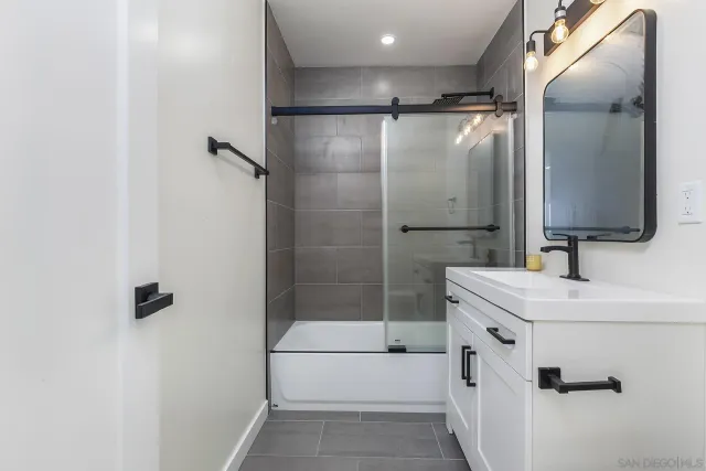 a bathroom with a shower sink and toilet