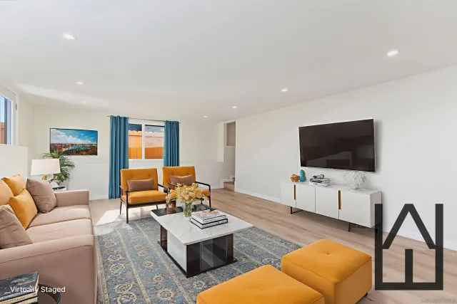 a view of a patio with couches and a potted plant on the wall