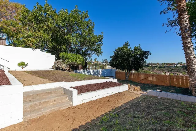 a view of a backyard with sitting area