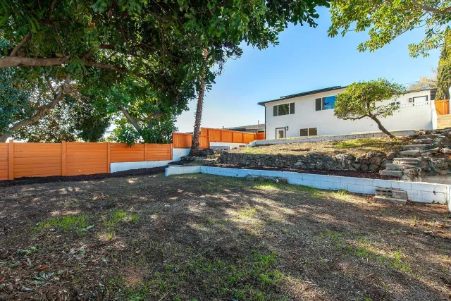 an aerial view of residential houses with city view