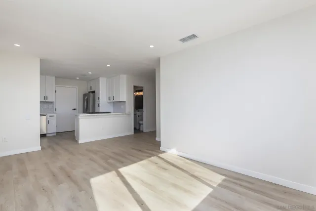 a view of a kitchen with a sink and cabinets