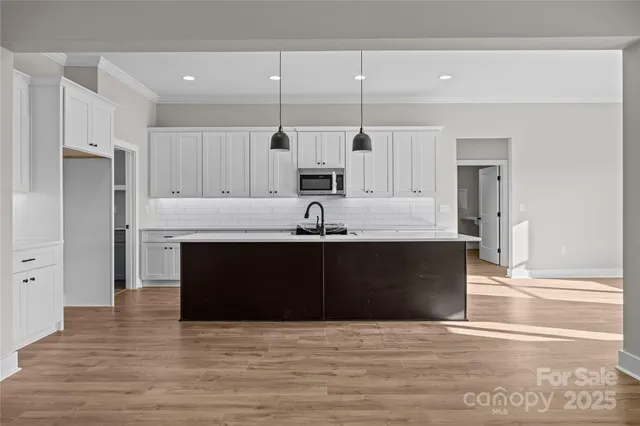 a kitchen with white cabinets and white appliances