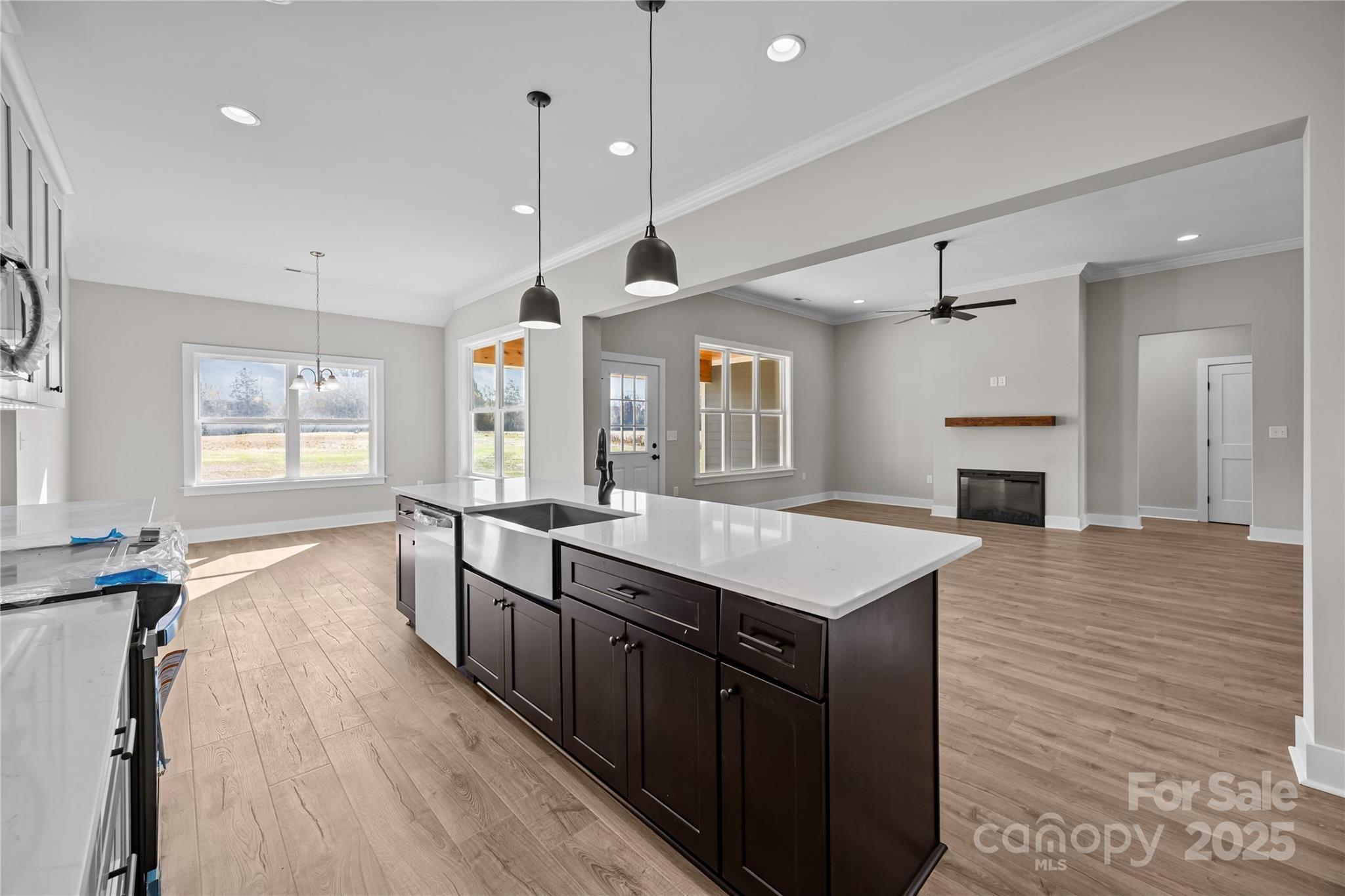 17826 Brattain Road Locust, NC 28097 - Photo 22 of 44 a large kitchen with kitchen island a sink a center island and wooden floor