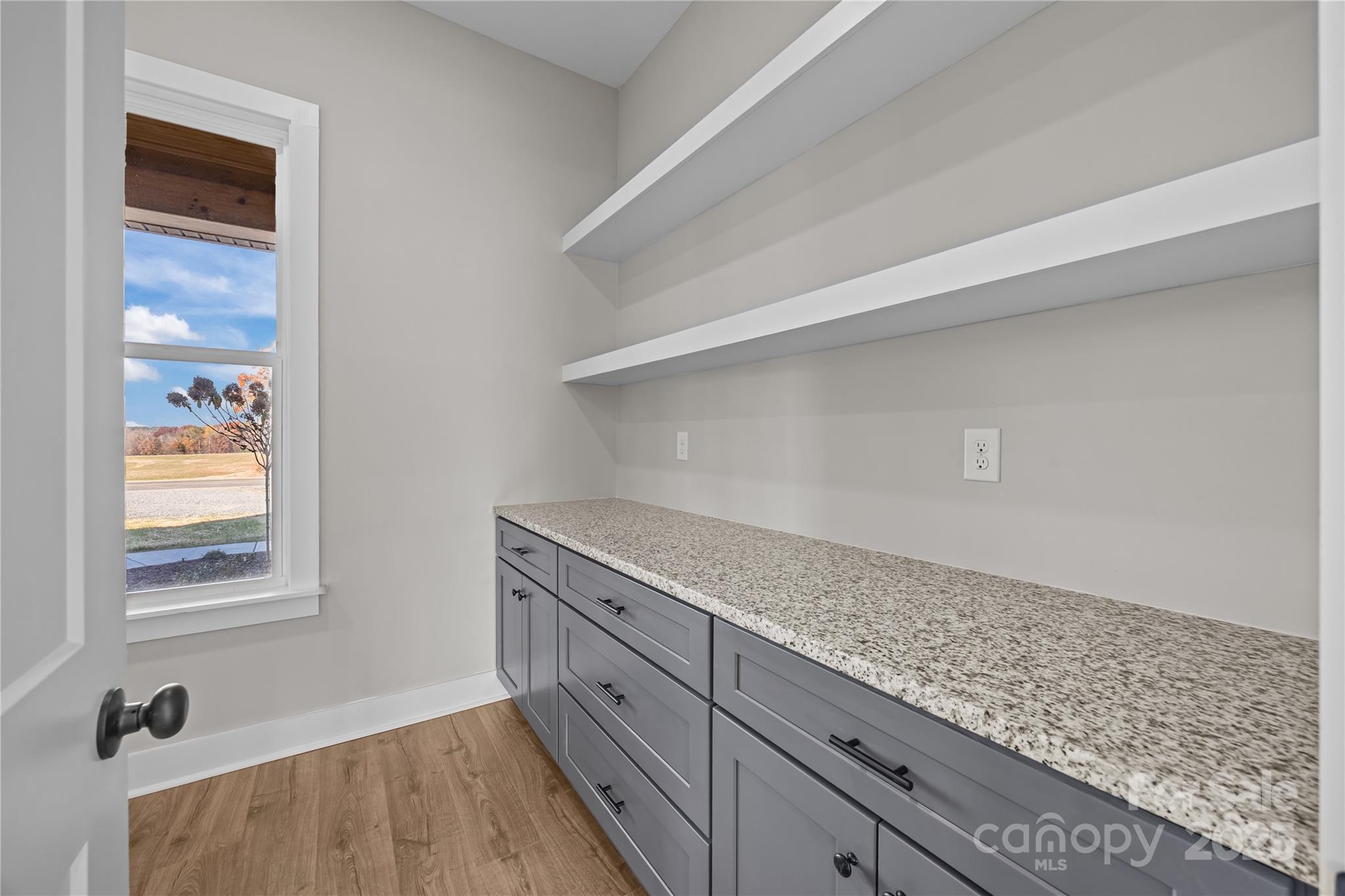 17826 Brattain Road Locust, NC 28097 - Photo 24 of 44 a kitchen with granite countertop white cabinets and window