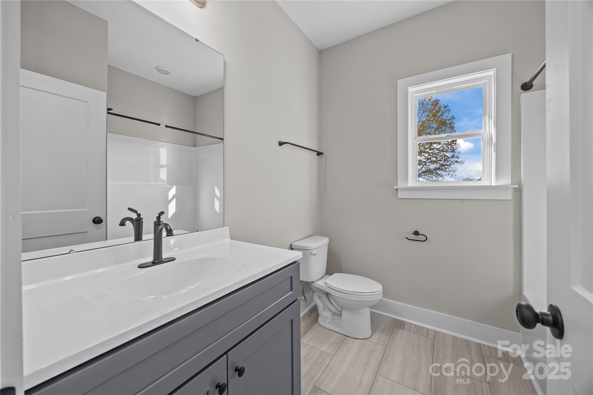 17826 Brattain Road Locust, NC 28097 - Photo 40 of 44 a bathroom with a sink a toilet and shower