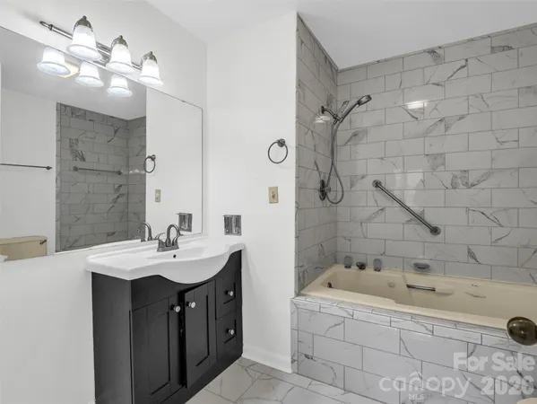 a bathroom with a bathtub and a sink