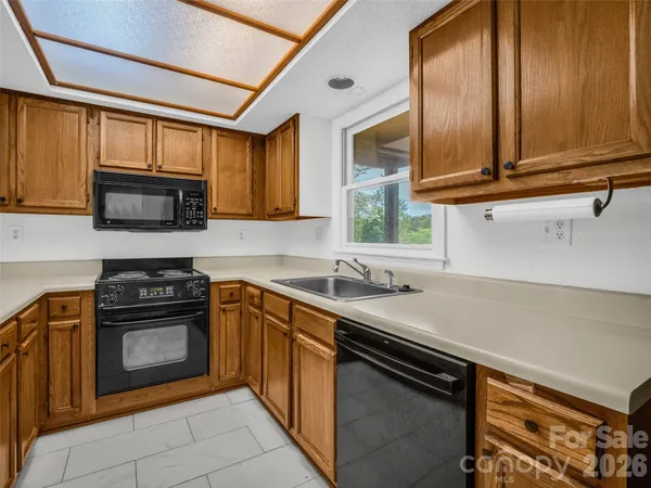 a kitchen with stainless steel appliances a stove sink and cabinets