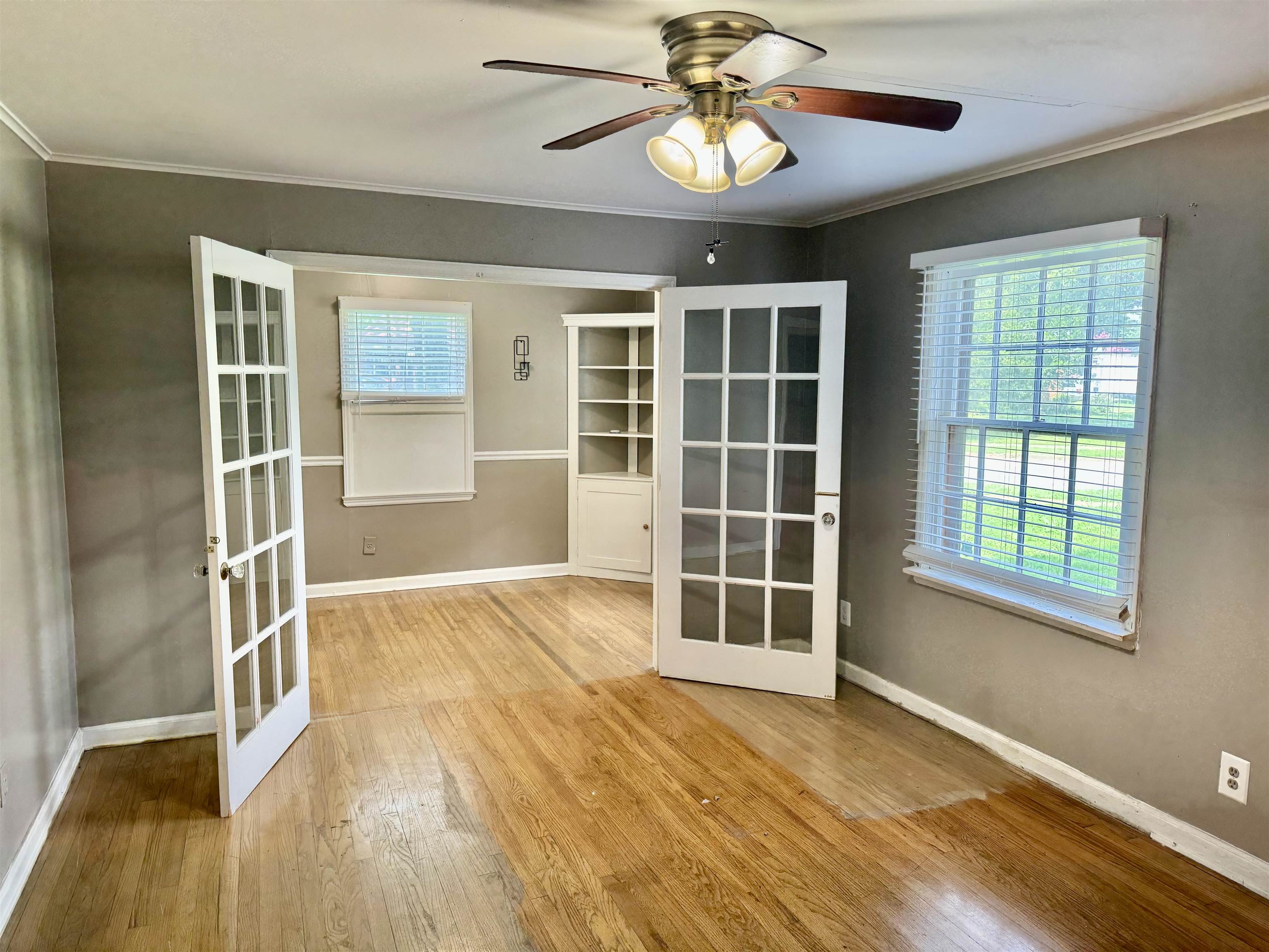 3787 Rhodes Avenue Memphis, TN 38111 - Photo 7 of 23 a view of an empty room with a window and wooden floor