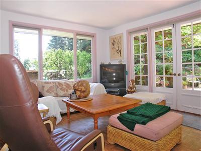 191 Lagunitas Road Ross, CA 94957 - Photo 6 of 11 a living room with furniture and a floor to ceiling window