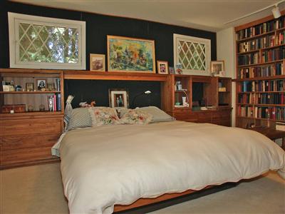 191 Lagunitas Road Ross, CA 94957 - Photo 7 of 11 a bed sitting in a bedroom next to a book shelf